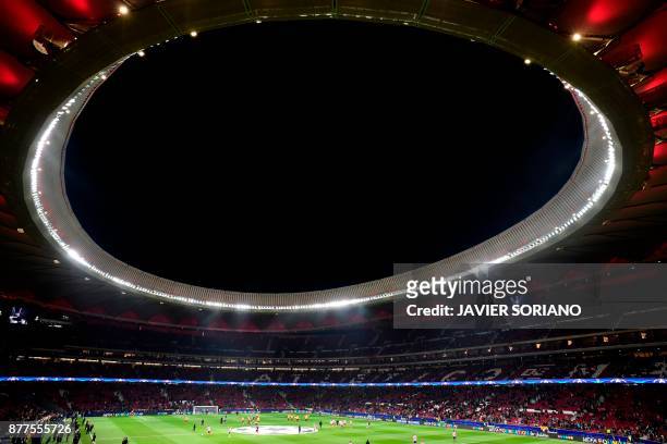 General view shows players warming up ahead of the UEFA Champions League group C football match between Atletico Madrid and AS Roma at the Wanda...