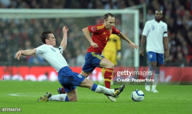 Scott Parker of England tries to tackle Andres Iniesta of Spain during an International Friendly match at Wembley Stadium on November 12, 2011 in...