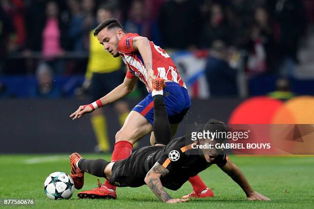 Roma's Argentinian midfielder Diego Perotti challenges Atletico Madrid's Spanish midfielder Saul Niguez during the UEFA Champions League group C...