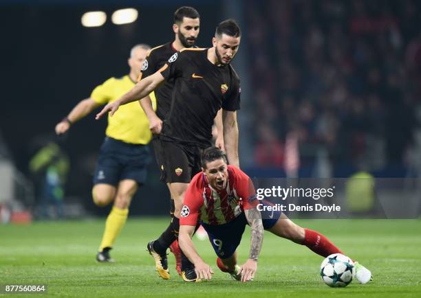 Maxime Gonalons of AS Roma tackles Fernando Torres of Atletico Madrid during the UEFA Champions League group C match between Atletico Madrid and AS...