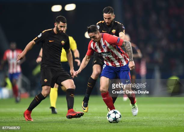 Maxime Gonalons of AS Roma tackles Fernando Torres of Atletico Madrid during the UEFA Champions League group C match between Atletico Madrid and AS...