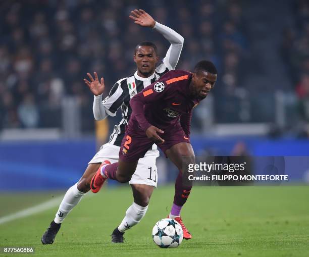 Barcelona's Portuguese defender Nelson Semedo vies with Juventus' forward from Brazil Douglas Costa during the UEFA Champions League Group D football...