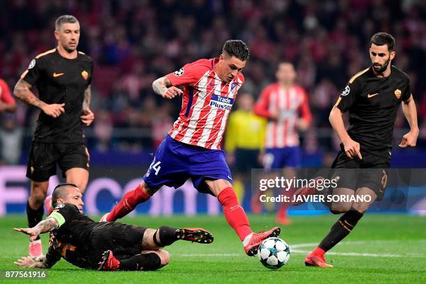 Atletico Madrid's Uruguayan defender Jose Gimenez challenges Roma's Belgian midfielder Radja Nainggolan , Roma's Croatian defender Aleksandar Kolarov...