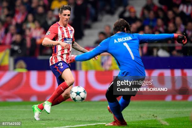 Roma's Brazilian goalkeeper Alisson stops a shot on goal by Atletico Madrid's Spanish forward Fernando Torres during the UEFA Champions League group...