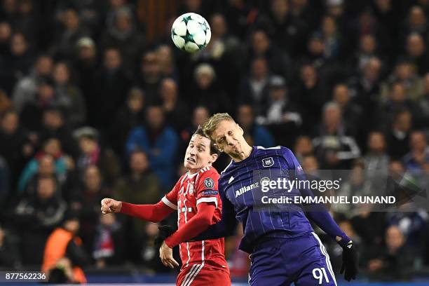 Anderlecht's Polish forward Lukasz Teodorczyk heads the ball with Bayern Munich's German midfielder Sebastian Rudy during the UEFA Champions League...