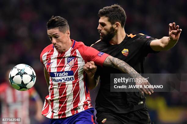 Roma's Argentinian defender Federico Fazio challenges Atletico Madrid's Spanish forward Fernando Torres during the UEFA Champions League group C...