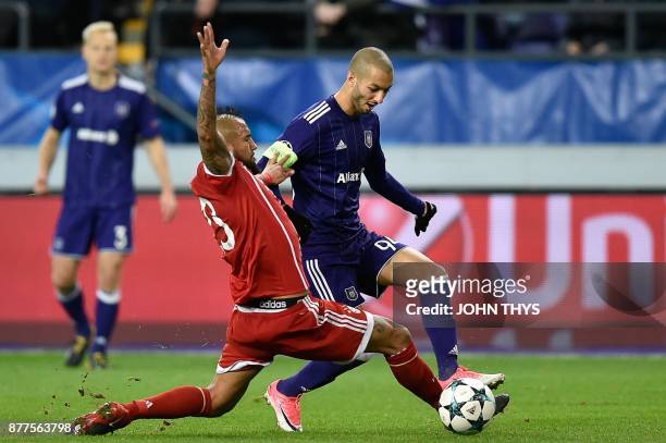 Bayern Munich's Chilean midfielder Arturo Vidal vies with Anderlecht's Algerian midfielder Sofiane Hanni during the UEFA Champions League Group B...
