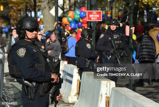 New York Police Department officers patrol and secure crowds during the Macy's Parade balloon inflation November 22, 2017. New York city is on high...