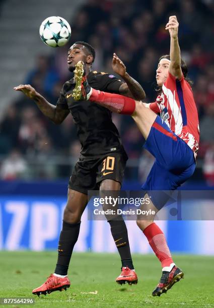 Filipe Luis of Atletico Madrid challenges Gerson of AS Roma during the UEFA Champions League group C match between Atletico Madrid and AS Roma at...