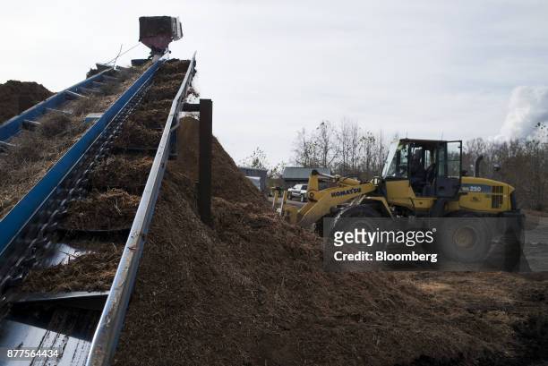 An employee operates a Komatsu Ltd. WA250 wheel loader next to a pile of mulch at the Cyblair Sawmill in West Columbia, West Virginia, U.S., on...
