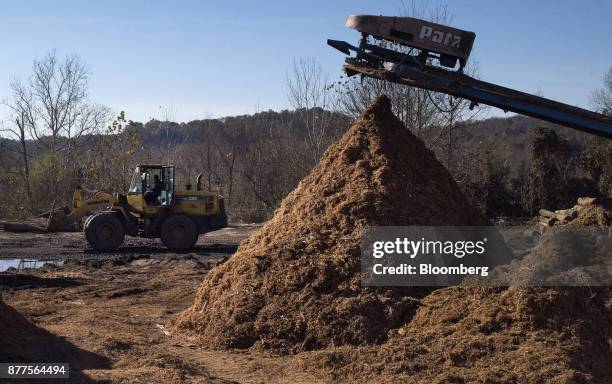 An employee operates a Komatsu Ltd. WA250 wheel loader next to a pile of mulch at the Cyblair Sawmill in West Columbia, West Virginia, U.S., on...