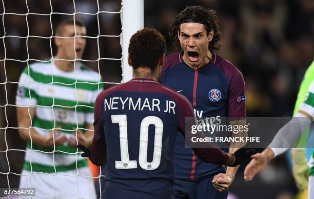 Paris Saint-Germain's Uruguayan striker Edinson Cavani celebrates with teammate Brazilian striker Neymar after scoring his team's third goal during...