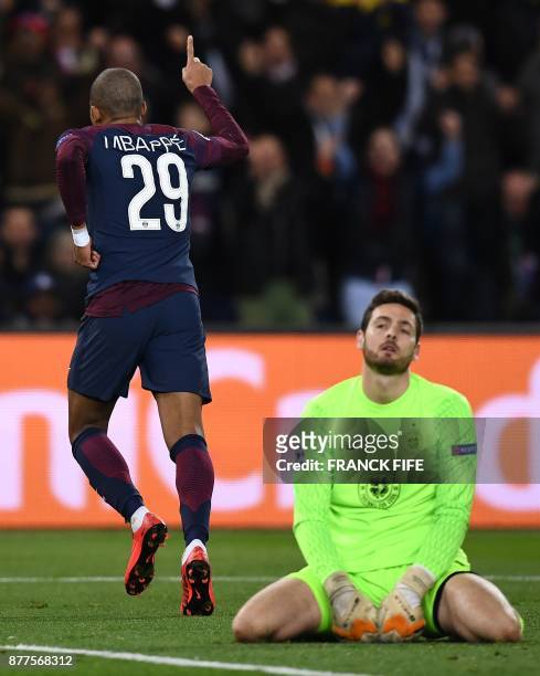 Celtic's Scottish goalkeeper Craig Gordon looks on as Paris Saint-Germain's French striker Kylian Mbappe celebrates scoring his team's fourth goal...