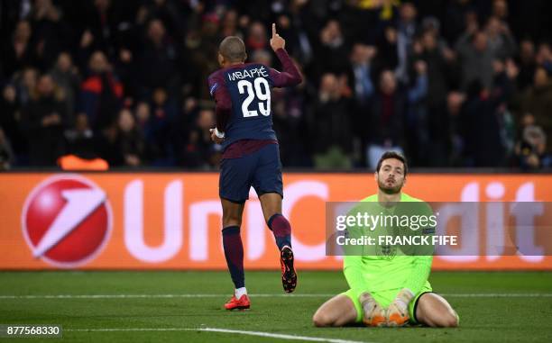 Celtic's Scottish goalkeeper Craig Gordon looks on as Paris Saint-Germain's French striker Kylian Mbappe celebrates scoring his team's fourth goal...