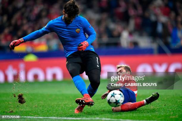 Roma's Brazilian goalkeeper Alisson blocks a shot on goal by Atletico Madrid's French forward Antoine Griezmann during the UEFA Champions League...