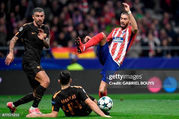 Atletico Madrid's Belgian midfielder Yannick Ferreira-Carrasco challenges Roma's Croatian defender Aleksandar Kolarov and Roma's Greek defender...