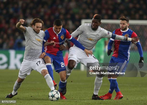 Daley Blind and Paul Pogba of Manchester United in action with Mohamed Elyounoussi and Renato Steffen of FC Basel during the UEFA Champions League...