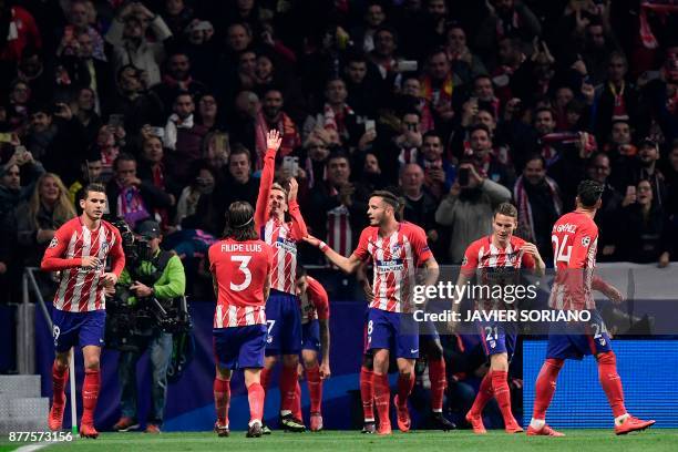 Atletico Madrid's French forward Antoine Griezmann celebrates with teammates after scoring a goal during the UEFA Champions League group C football...