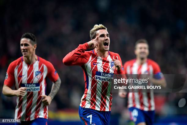 Atletico Madrid's French forward Antoine Griezmann celebrates with teammates after scoring a goal during the UEFA Champions League group C football...