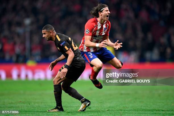 Roma's Brazilian defender Bruno Peres fouls Atletico Madrid's Brazilian defender Filipe Luis before being sent off during the UEFA Champions League...