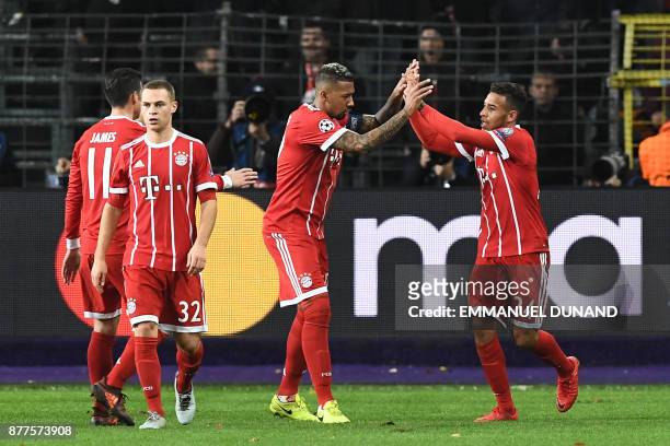 Bayern Munich's French midfielder Corentin Tolisso celebrates with teammates after scoring a goal during the UEFA Champions League Group B football...