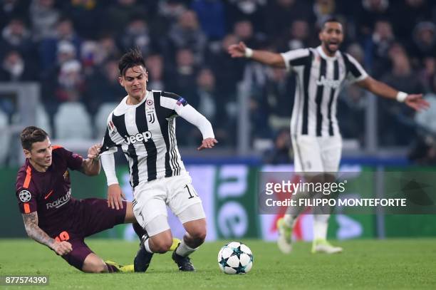 Barcelona's French defender Lucas Digne fights for the ball with Juventus' forward from Argentina Paulo Dybala during the UEFA Champions League Group...