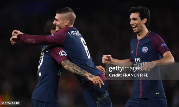 Paris Saint-Germain's Italian midfielder Marco Verratti celebrates with teammates after scoring during the UEFA Champions League Group B football...