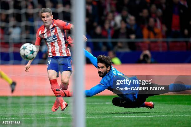 Atletico Madrid's French forward Kevin Gameiro scores past Roma's Brazilian goalkeeper Alisson during the UEFA Champions League group C football...