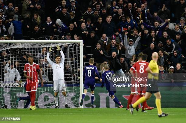 Fans and Bayern Munich's players react after Anderlecht's Algerian midfielder Sofiane Hanni scored a goal during the UEFA Champions League Group B...