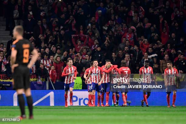 Atletico Madrid's players celebrate their second goal during the UEFA Champions League group C football match between Atletico Madrid and AS Roma at...