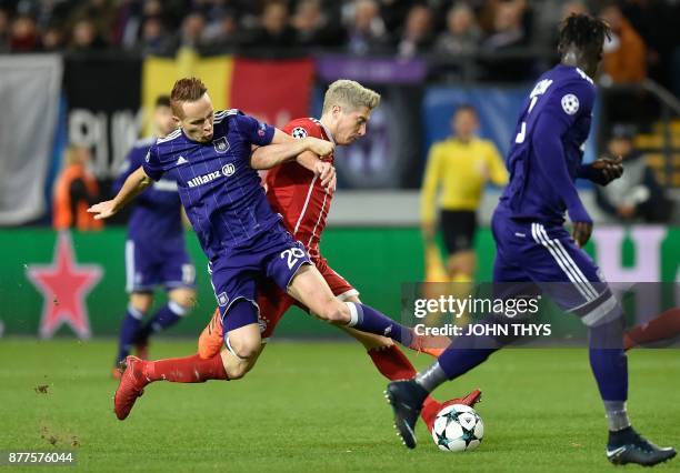 Anderlecht's French midfielder Adrien Trebel vies with Bayern Munich's Polish forward Robert Lewandowski during the UEFA Champions League Group B...