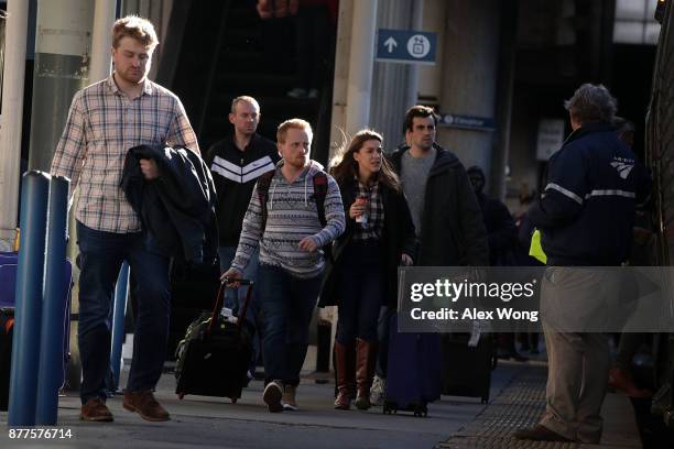 Passengers prepare to board a train at Union Station November 22, 2017 in Washington, DC. The American Automobile Association has predicted that...