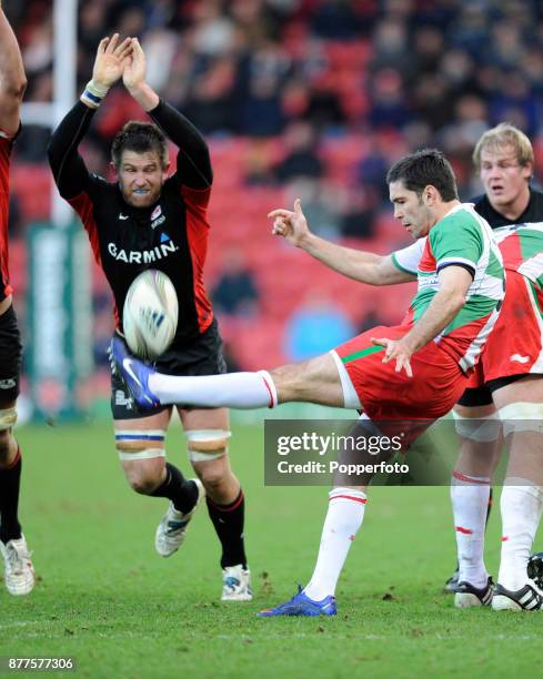 Dimitri Yachvili of Biarritz clears his line as Ernst Joubert of Saracens attempts to block him during the Heineken Cup Pool 5 match between Saracens...