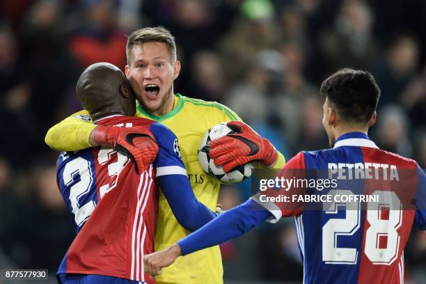 Basel's Czech goalkeeper Tomas Vaclik celebrates with teammates Colombian defender Eder Balanta and Italian defender Raoul Petretta after winning at...