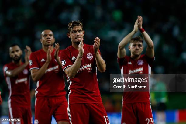 Olympiakos's midfielder Guillaume Gillet , Olympiakos's midfielder Leonardo Koutris and Olympiakos's defender Vadis Odjidja-Ofoe salutes the fans at...