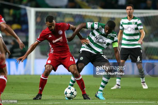 Olympiacos' midfielder Alaixys Romao vies with Sporting's midfielder William Carvalho from Portugal during the UEFA Champions League group D football...