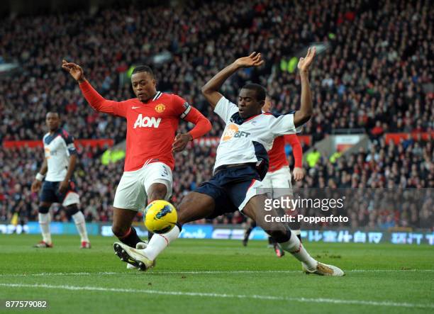 Patrice Evra of Manchester United and Fabrice Muamba of Bolton Wanderers battle for the ball during a Barclays Premier League match at Old Trafford...