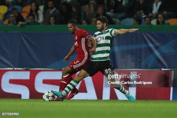 Olympiakos Piraeus midfielder Mehdi Carcela Gonzalez from Marrocos vies with Sporting CP defender Cristiano Piccini from Italy for the ball...