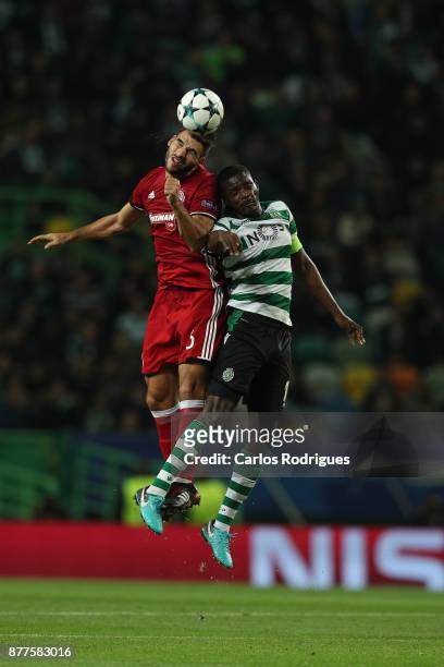 Olympiakos Piraeus defender Alberto Botia from Spain vies with Sporting CP midfielder William Carvalho from Portugal for the ball possession during...