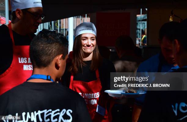 Actress Emmy Rossum helps out at the Los Angeles Mission's annual Thanksgiving meal for the homeless on November 22, 2017 in Los Angeles, California...