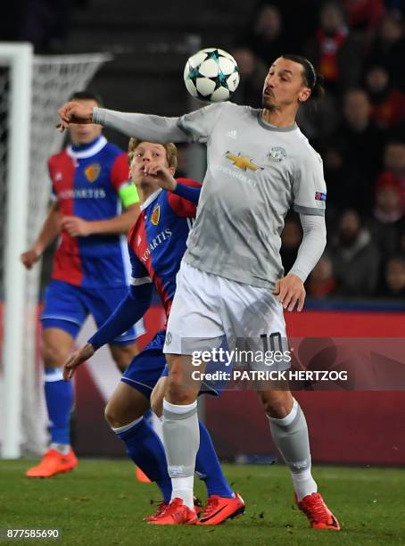 Manchester United's Swedish forward Zlatan Ibrahimovic vies with Basel's Czech defender Marek Suchy during the UEFA Champions League Group A football...