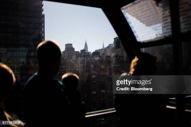 The Chrysler Building stands in the Manhattan skyline as commuters ride the Roosevelt Island Tramway in New York, U.S., on Tuesday, Oct. 17, 2017....