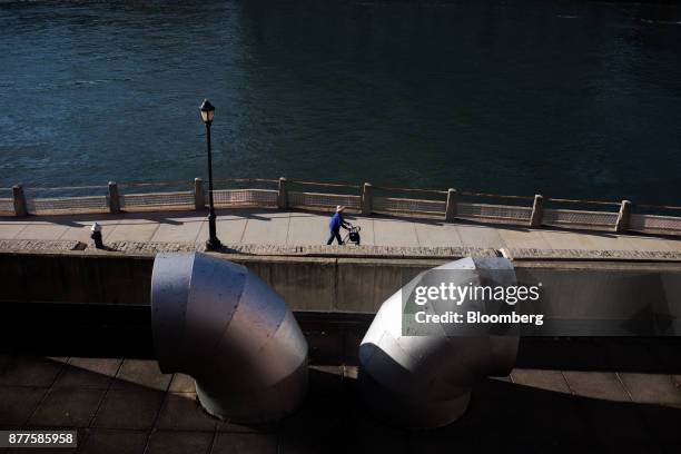 Pedestrian walks along the East River on Roosevelt Island in New York, U.S., on Tuesday, Oct. 17, 2017. Cornell Techion, a new technology-oriented...