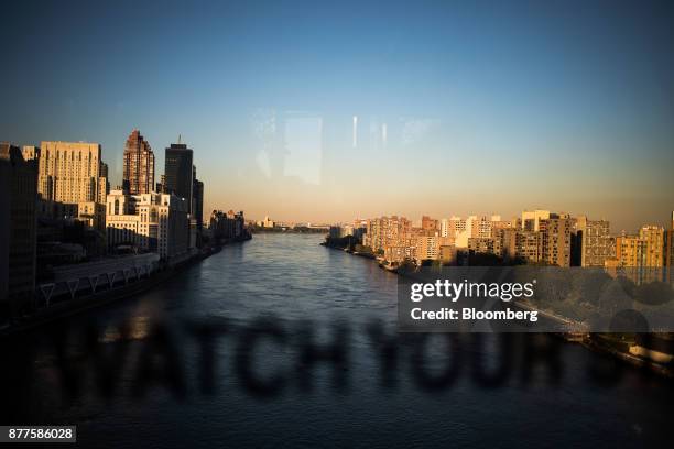 Apartment buildings, right, stand across the East River from Manhattan as seen from the Roosevelt Island Tramway above Roosevelt Island in New York,...
