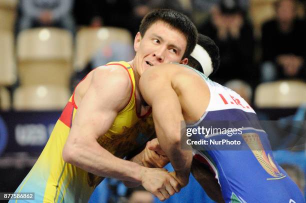 Kazakhstans Abylaikhan Amzeyev competes with Irans Amin Yavar Kaviyaninejad during the Senior U23 Wrestling World Championships in the 66 kg class on...