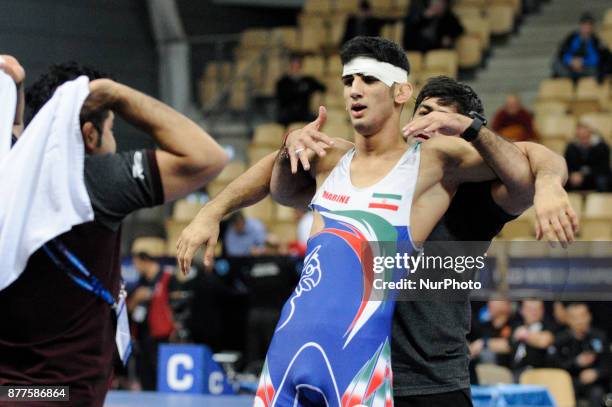 Kazakhstans Abylaikhan Amzeyev competes with Irans Amin Yavar Kaviyaninejad during the Senior U23 Wrestling World Championships in the 66 kg class on...