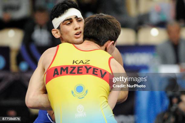 Kazakhstans Abylaikhan Amzeyev competes with Irans Amin Yavar Kaviyaninejad during the Senior U23 Wrestling World Championships in the 66 kg class on...