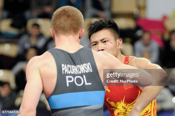 Chinas Gaoquan Zhang competes with Polands Roman Pacurkowsi during the Senior U23 Wrestling World Championships in the 66 kg class on November 22,...