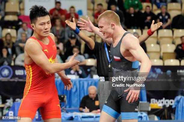 Chinas Gaoquan Zhang competes with Polands Roman Pacurkowsi during the Senior U23 Wrestling World Championships in the 66 kg class on November 22,...