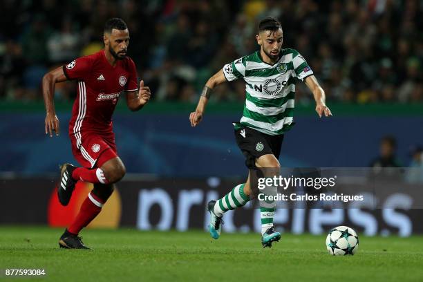 Sporting CP midfielder Bruno Fernandes from Portugal tries to escape Olympiakos Piraeus midfielder Alaixys Romao from Tongo during the UEFA Champions...